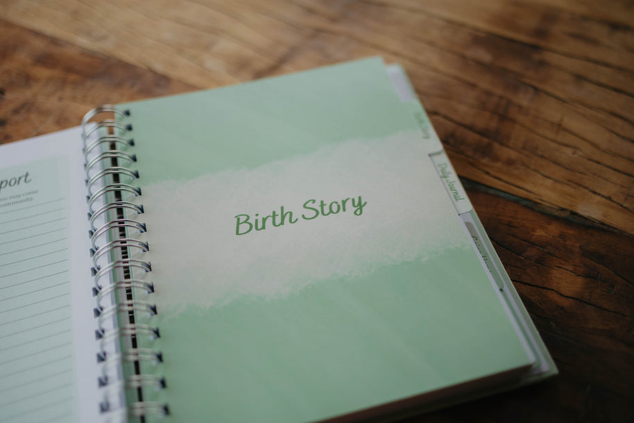 A close up of the Birth Story  section tab page in The NICU Notebook®, a light green, coil bound NICU Journal for families with a baby in the Neonatal Intesive Care Unit, on a wooden table top.