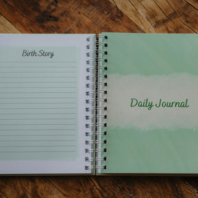 A close up of the last lined page in the Birth Story section and the Daily Journal tab page in The NICU Notebook®, a light green, coil bound NICU Journal for families with a baby in the Neonatal Intesive Care Unit, on a wooden table top.